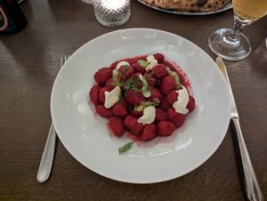 beetroot gnocchi with vegan ricotta, walnut pesto, and tarragon  at Piu in Bern