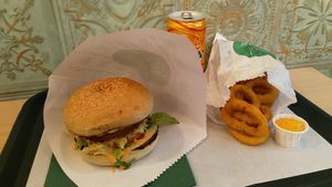Amarillo burger, onion rings and a soft drink. at Veganer  in Sarajevo