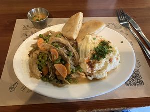 Not pollo arvejado, puré de papas, sopaipillas con pebre.    at Enki in Valdivia