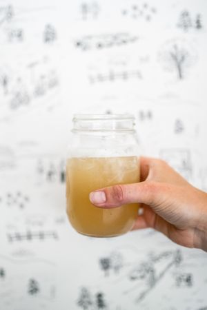 A maple lemonade in front of the custom PK wallpaper featured at the Stowe shop. at PK Coffee in Stowe
