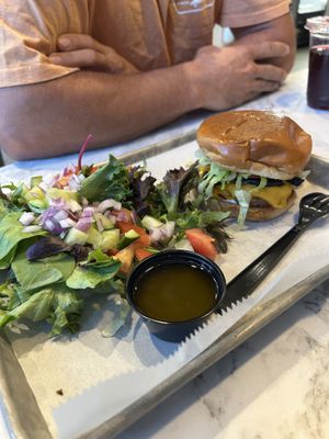 Mushroom burger with a side of salad at Brick City Vegan in Newark