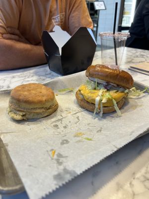 Spicy chicken sandwich with a biscuit side at Brick City Vegan in Newark