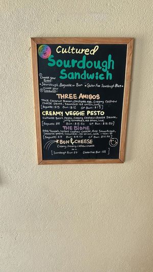 The Cultured Sourdough sandwich menu: a choice of sourdough baguette, sourdough bun, or gluten free sourdough bun, and various filling options. at It's Alive Bakery & Fermentory in Rodney Bay