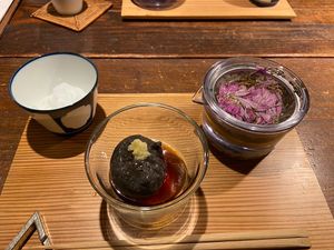 Our dessert! This beautiful herbal floral iced tea and black sesame pudding?  at AWOMB Nishikiyamachi in Kyoto