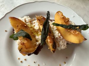 Crostini w whipped ricotta, peaches - vegan version.   at Gia in Toronto