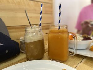 Left: iced cinnamon coffee shake made with coconut milk. Right: Papaya Passion- papaya, orange, lime, mint  at AUYAMA real food in Tenerife