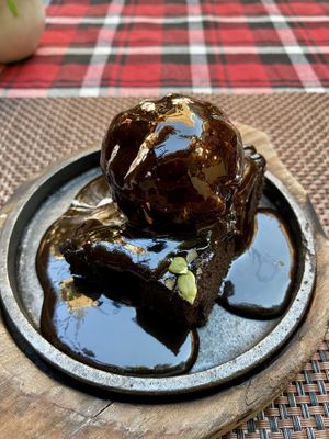 Sizzling brownie: vegan brownie with vegan vanilla ice cream on top and fudge poured over at the table.  at Always Happy Food co. in Kathmandu