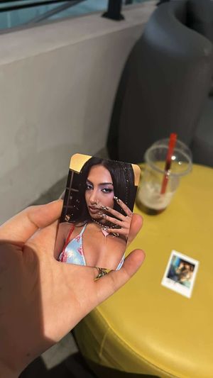 Photo cards and a mango tea (mostly gone) in the back  at Fam Kpop and Bubble Tea in Sofia