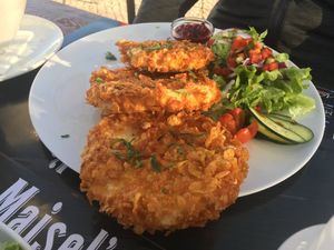 Celery schnitzel with greens and cold potato salad at Munich in Lagos