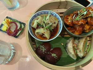 1st round of Favourites menu (2 persons) with pickled veggies, wonton, crispy cauliflower wings, nigiri and gyoza at Veganees in Amsterdam