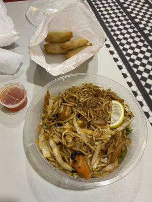 Noodles, vegan chicken in black bean sauce and spring rolls-take out at Vegan Fusion in North London