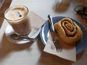 Coffee with soy milk and cinnamon roll at La Tribu - Pastelería Vegana in Barcelona