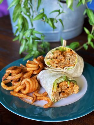 Buffalo Wrap with buffalo seitan, romaine lettuce and ranch dressing in a flour tortilla. Served with your choice of curly fries or house salad. at Pauseitively Vegan in Deerfield Beach
