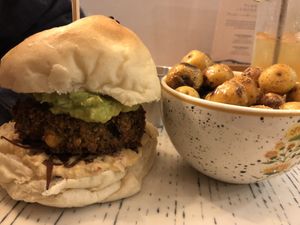Burger with chickpea patty. Potatoes on the side.   at Vegan & Veggie in Medellin