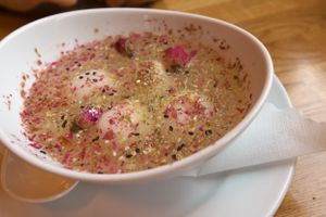 The lovely, sticky rice balls filled with black sesame in a flower brew. at The Butterfly Lovers in Berlin