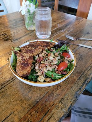Southern-Terranean--Grilled protein over baby greens and quinoa tossed with marinated cucumbers and cherry tomatoes, capers, spiced chickpeas, sweet onions, and herb feta, finished at The Floridian in St Augustine