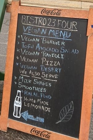 December 2023, sign on street advertising vegan menu  at Bistro 23 Four in Gozo
