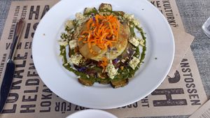 Potato gratin on grilled eggplant and zucchetti; oregano basil sauce verte; house pickled to-feta, carrot linguini and sunflower seeds. World class taste... at Mairübe in Luzern