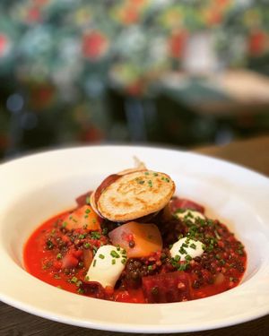 Borscht with lentils, root vegetables and home-made buckwheat blinis, topped with a soy dip and chives at Mairübe in Luzern
