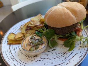 Burger and fried potatoes at REVIV in Malaga