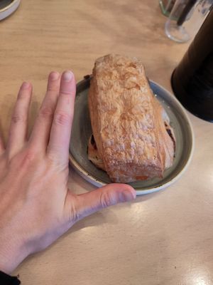 Trying to show the scale of the giant pain au chocolat at Stir - Chesterton in Cambridge