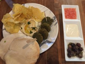 Tester plate : falafel, houmous, chips, pita, olives and sauces at Push Tak in Lisbon