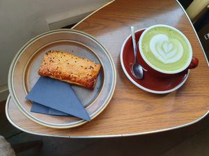 Saucijzenbroodje and matcha latte nicely decorated. at PUCK specialty coffee in Nijmegen