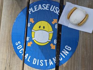 Outdoor seating benches, and a vanilla sugar cookie/lemon meringue (vegan) ice cream sandwich at Innocent Ice Cream Parlour in Vancouver