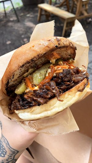 Mean Mr Mushroom - Pulled trumpet mushrooms, bbq sauce, vegan slaw, pickles, and hot sauce on a kaiser roll.  at Joust Juice in Rhinebeck