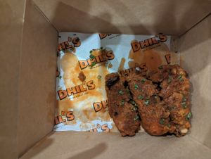 Buffalo wings (half eaten) at Dhil's in Wigston