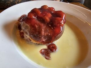 Baked doughnut with cherries and custard at The Bay Vegan Deli Coffee House in Sandown