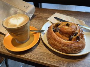 Oat latte and vegan pain aux raisins as big as my head  at The Press Room in Surbiton