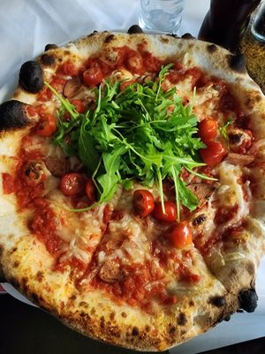 Arugula, cherry tomatoes, vegan sausage and vegan cheese at I Pazzi in Gdansk