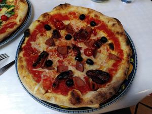 Pizza Grum, with vegan sausage, dried tomatoes, olives and marinated peppers at I Pazzi in Gdansk