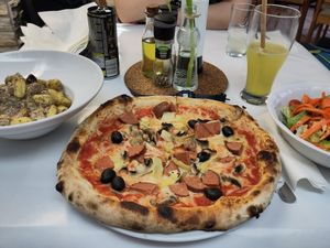 Vegan pizza wolf (ordered by my friend). Gnocchi Minchia are seen on the left at I Pazzi in Gdansk