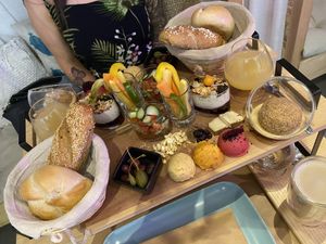vegan breakfast spread including 3 types of hummus, veggies, granola, bread, tofu, juice and Knödel  at Coolinarik in Salzburg