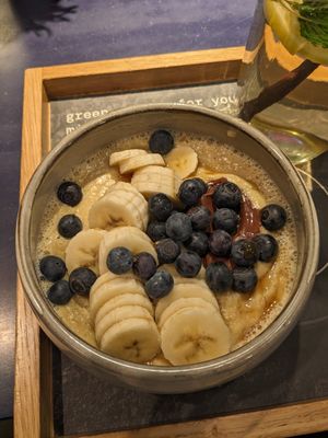 Create your own Porridge: Soja Vanilla Milk + Nougat Creme + blueberries + banana + maple sirup at The Naked Indigo in Salzburg