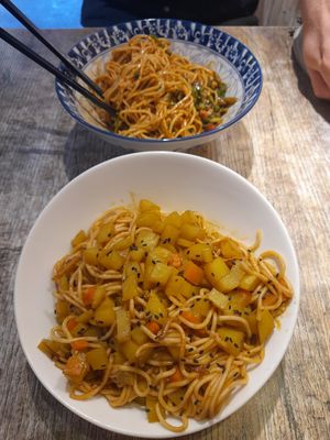 Potato curried moodles tŭdòu gālí miàn 土豆咖喱面, not spicy
15rmb (foreground)

And hot dry noodles règānmiàn 热干面 15rmb, vegan, only a little spicy (backgrou at Shi Zhiqian - 释之谦 - Maybe closed in Dali