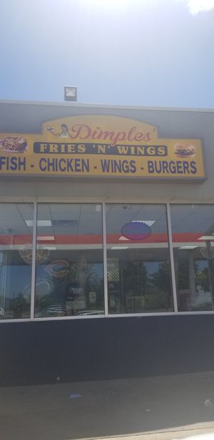 Storefront, connected to a gas station at Dimples Fries N Wings in Arlington