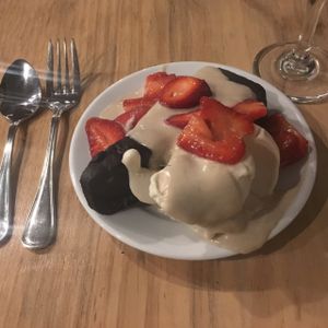 chocolate cake with side of vegan vanilla ice cream and fresh strawberries  at Julia's Vegetarian Restaurant in Pacific Grove