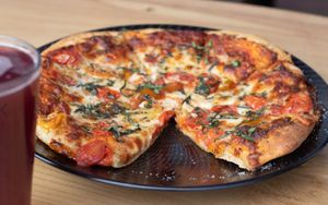 Our classic margherita pizza with our lhouse-brewed lemon elderberry kombucha at Julia's Vegetarian Restaurant in Pacific Grove