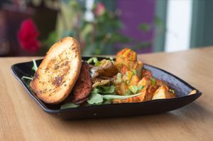 Vegan fried "egg" sandwich with "bacon" and crispy potatoes at Julia's Vegetarian Restaurant in Pacific Grove