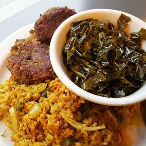 Patties, rice and greens with gravy at The Land of Kush in Baltimore