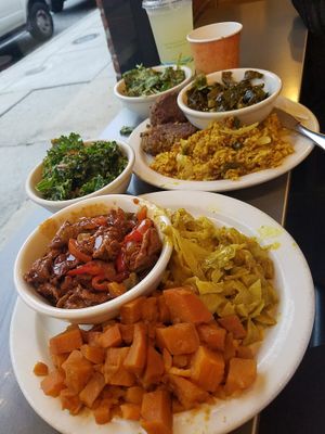 Feast with ribs, yams, cabbage, kale, spinach, rice, bean patties, greens at The Land of Kush in Baltimore