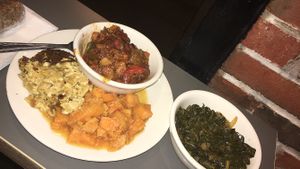Ribs, macaroni, sweet potato, and greens  at The Land of Kush in Baltimore