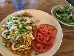 Potato Leek Omlette (tofu, vegan cheese & sour cream) with side of tomatoes & greens at Bouldin Creek Cafe in Austin