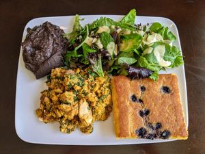 Tofu house omelet, field greens & citrus vinaigrette, refried black beans,  blueberry cornbread at Bouldin Creek Cafe in Austin