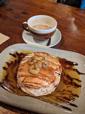 Caramelised banana pancakes and oat latte. at Scoff's Coffee House in Coleford
