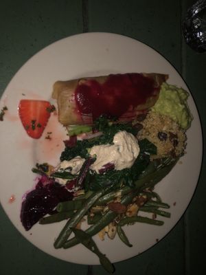 Ate outside and forgot to take pic first. Pickled mint 🍓, tamale, kale and cashew cheese salad, green beans, beats, quinoa dish, all very tasty and filling!! at Casa de Luz in Austin