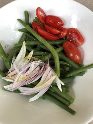 Green collards, tomatoes, and fresh red onion  at Kipling in Turin